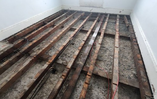 Cleaned floor voids following the safe removal of asbestos-containing debris from a listed London building.